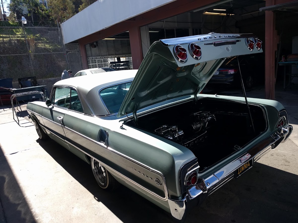 Teal classic with trunk open after restoration